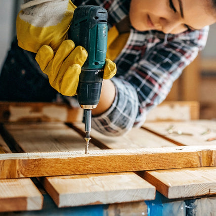 HardwareA contractor using a power drill on a wood screw